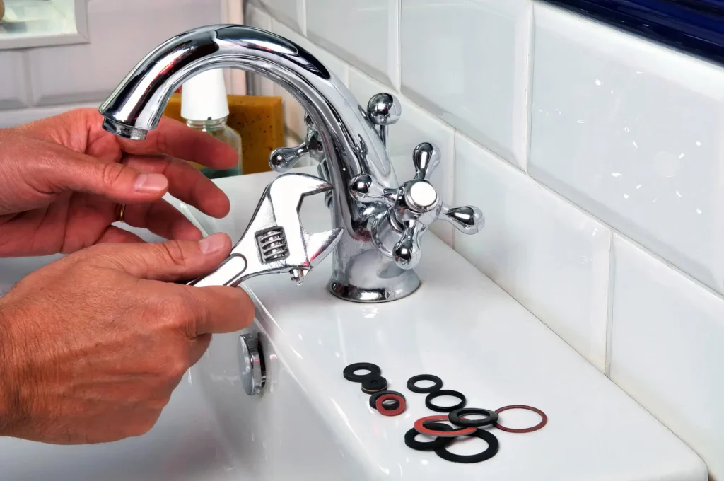 Plumber performing maintenance on a bathroom faucet in Merritt Island