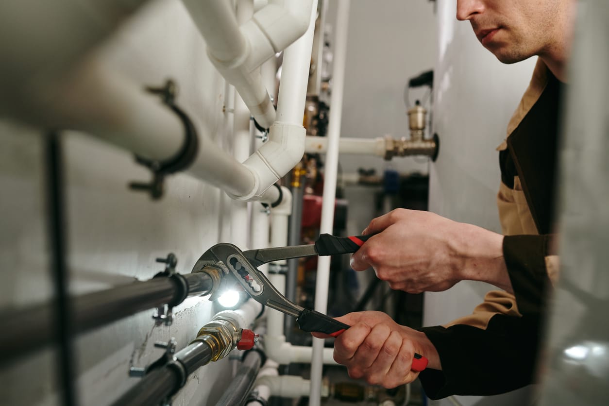 Plumbers maintaining commercial plumbing pipes in Merritt Island