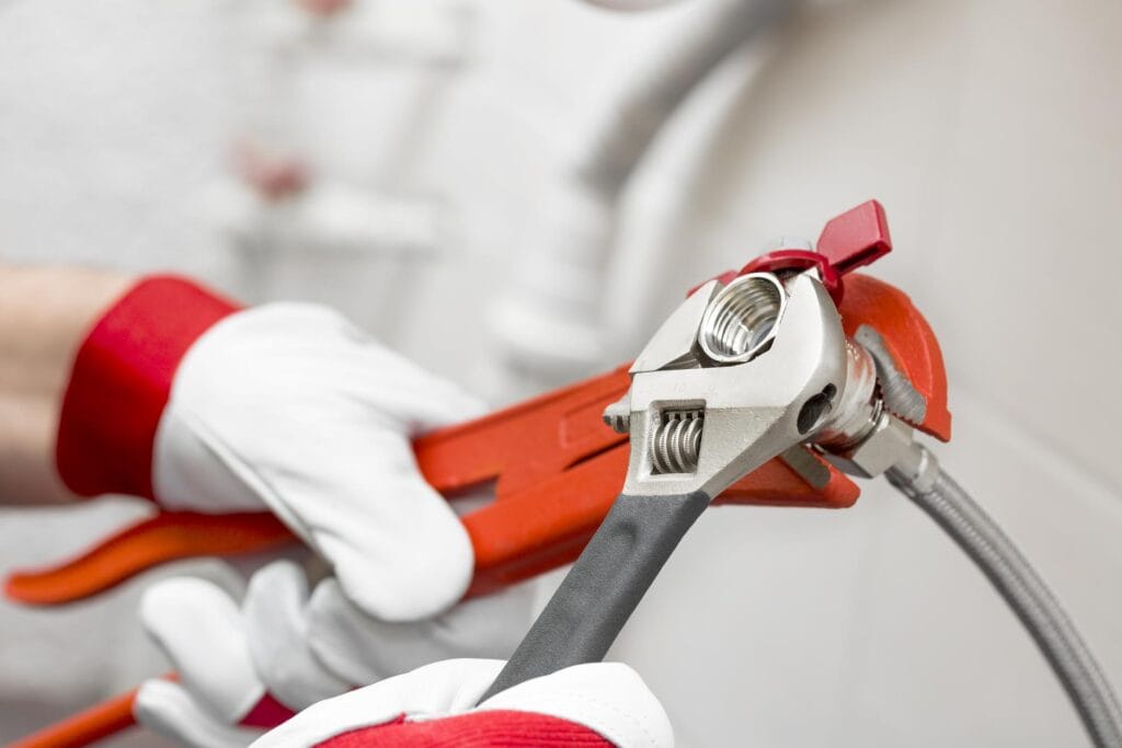 Plumber holding pipe wrenches for an emergency repair in Merritt Island