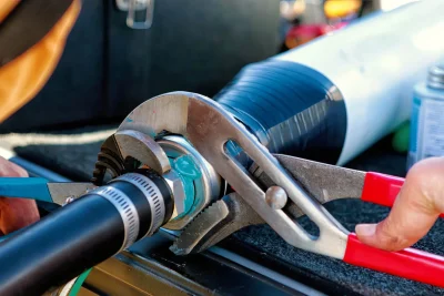 Technician tightening an industrial pipe connection in Merritt Island