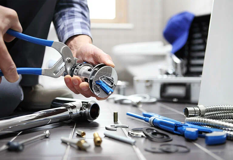 Technician repairing a plumbing fixture with professional tools in Merritt Island