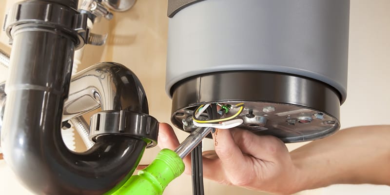 Technician repairing the heating element of a water heater in Merritt Island