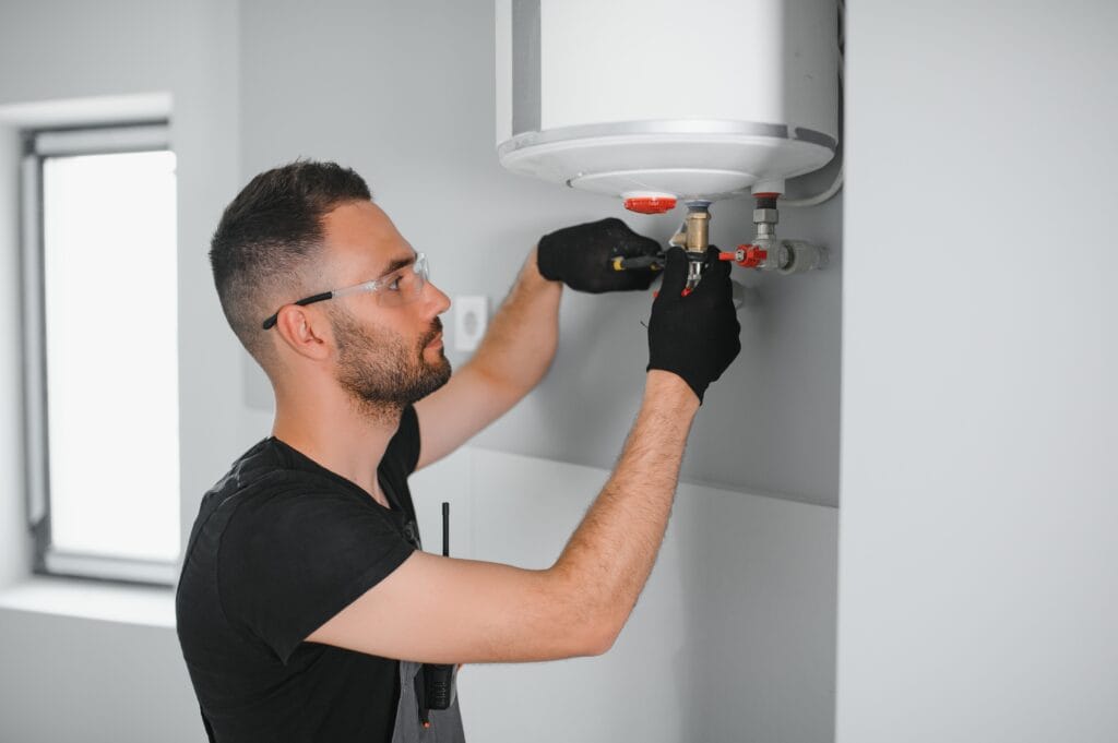 Technician performing water heater maintenance in Merritt Island