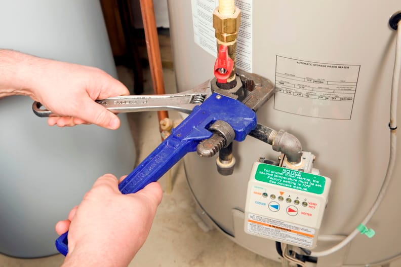 Plumber repairing a water heater valve in Merritt Island